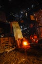 Indonesian woman in the rural kitchen preparing food on the fire pit ins