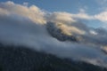 Mount Sass de Stria at sunrise, blue sky with clouds and fog, Falzarego pass, Dolomites, Veneto, Italy