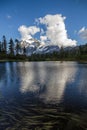 Reflections of Mount Shuksan and cumulus cloud in Picture Lake Royalty Free Stock Photo