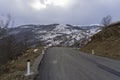 Mountain asphalt road leading to Didgori battle memorial, Georgia. Winter and snow, overcast