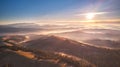 Mountain autumn Sunrise. Majestic Morning fog, Beautiful tonal perspective. Fall sunny Landscape, misty forest on hills. Majestic Royalty Free Stock Photo