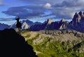 Mountain background with black silhouette of mountain goat in front.