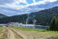 Mountain beach on a artificial lake in Carpathian. Summer time in Bukovel ski resort Royalty Free Stock Photo