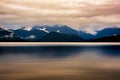 The mountain behind Lake Kaniere being reflected on the lake surface on a dark and rainy wet cloudy moody late afternoon