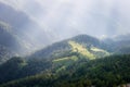 Mountain Big Thach in Caucasus. View from the top of the mountain through the rocks to a green meadow and conifers Royalty Free Stock Photo