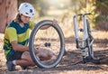 Mountain bike cycling, tire repair and man check, fix or does maintenance on broken or damaged bicycle wheel. Fitness Royalty Free Stock Photo