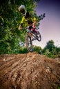 Mountain bike cyclist doing stoppie, ridden on the front wheel