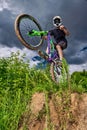 Mountain bike cyclist doing wheelie stunt on a mtb bike