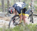 Mountain bike cyclist fixing a flat tire in the forest Royalty Free Stock Photo