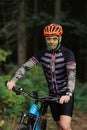 Mountain bike cyclist in sport equipment and helmet riding on rugged trails Royalty Free Stock Photo