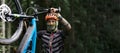 Mountain bike cyclist in sport equipment and helmet riding on rugged trails Royalty Free Stock Photo