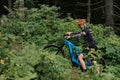 Mountain bike cyclist in sport equipment and helmet riding on rugged trails Royalty Free Stock Photo