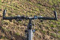 Mountain bike handlebar seen from the first person perspective. Visible bicycle frame and bicycle accessories on the handlebar and