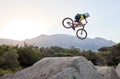 Mountain bike, jump and man doing extreme stunt while training or riding in competition. Bicycle, sports and athlete or Royalty Free Stock Photo