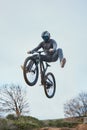 Mountain, bike jump and person cycling on bicycle for extreme sports competition stunt or training in nature. Skill Royalty Free Stock Photo