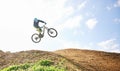 Mountain bike, man and jump in sky for competition, freedom and off road adventure. Athlete, extreme sports and bicycle Royalty Free Stock Photo