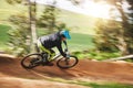 Mountain bike, man and motion blur in forest for competition, speed or off road adventure on path. Fast athlete, sports