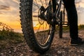 Mountain bike rear wheel detail. Back shot of mountain bike on sunset. Mountain bike tire.