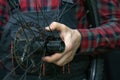 mountain bike repair. Bike mechanic in the workshop. Replacing grease and bicycle hub bearings. The mechanic is holding a wheel in Royalty Free Stock Photo