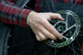 mountain bike repair. Bike mechanic in the workshop. Replacing grease and bicycle hub bearings. The mechanic is holding a wheel in Royalty Free Stock Photo