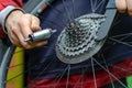 mountain bike repair. The master holds in his hand a tool for removing the cassette. sprocket remover chain whip