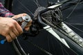 Mountain bike repair in the workshop. Mechanic's hands and tool close-up. The mechanic cuts off the old cable. A
