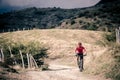 Mountain bike rider on country road, track trail in inspirational landscape Royalty Free Stock Photo