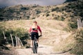 Mountain bike rider on country road, track trail in inspirational landscape Royalty Free Stock Photo