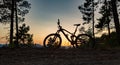 Mountain bike sunset silhouette on forest trail, inspiring lands Royalty Free Stock Photo