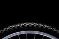 Mountain bike tire and rim on black