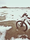 Mountain bike wheel broke through ice into water. Enjoy winter biking with fun Royalty Free Stock Photo