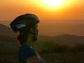 Mountain bike - woman with a bicycle helmet admiring the sunset Royalty Free Stock Photo