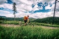 Mountain biker cycling riding bikepacking in woods and mountains Royalty Free Stock Photo