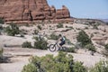 Mountain biker female woman riding her fat tire bike on slickrock in Moab Utah Royalty Free Stock Photo