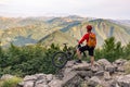 Mountain biker looking at view on bike trail in autumn mountains Royalty Free Stock Photo