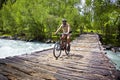 Mountain biker on old wooden bridge Royalty Free Stock Photo