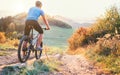 Mountain biker ride down from hill. Active and sport leisure con Royalty Free Stock Photo