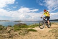 Mountain biker riding on bike at the sea and summer mountains. Royalty Free Stock Photo