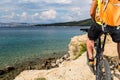 Mountain biker riding on bike at the sea and summer mountains Royalty Free Stock Photo