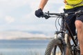 Mountain biker riding on bike at the sea and summer mountains. Royalty Free Stock Photo