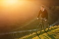 Mountain biker riding on bike in spring inspirational mountains landscape. inspiration outdoors in sunset.