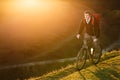 Mountain biker riding on bike in spring inspirational mountains landscape. inspiration outdoors in sunset. Royalty Free Stock Photo