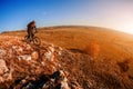 Mountain biker riding on bike at summer mountains. inspiration in beautiful inspirational landscape. Royalty Free Stock Photo