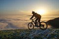 Mountain Biker Riding Downhill  Above the Clouds Royalty Free Stock Photo