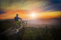 Mountain biker riding at sunset on bike in summer mountains fore