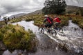 Mountain Bikers riding through flooded marshland