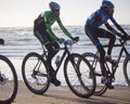 Mountain bikers taking part in the beach race Egmond-Pier-Egmond ride along the sea shore Royalty Free Stock Photo