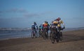 Mountain bikers taking part in the beach race Egmond-Pier-Egmond ride along the sea shore