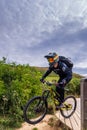 A mountain bikers wearing safety gears jumping downhill, Etretat, France Royalty Free Stock Photo