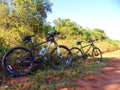 Mountain bikes next to a dirt road